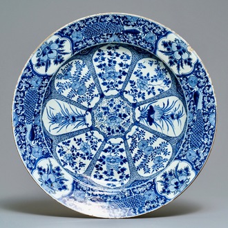 Un grand plat en porcelaine de Chine bleu et blanc à bordure aux paons, Kangxi